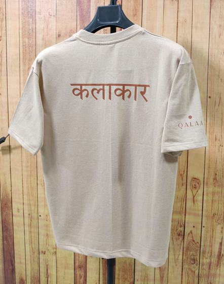 Beige oversized cotton t-shirt on hanger with rust Hindi word printed on back, custom made for Qalaa by RestroCart, New Delhi