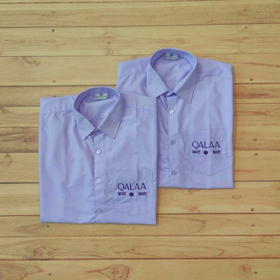 Two lavender full sleeve shirts with purple embroidered logo on chest pocket, folded, custom made for Qalaa by RestroCart, New Delhi