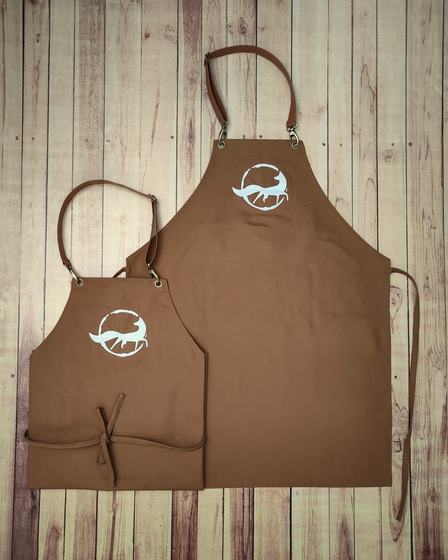 Brown canvas bib and waist apron pair with white printed fox logo and leather straps, custom made by RestroCart, New Delhi