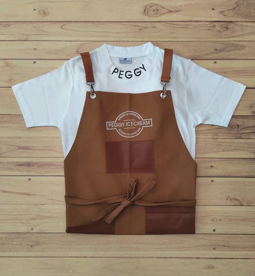 White round neck t-shirt worn under a tan bib apron with leatherette straps and pocket, logo print, custom made by RestroCart, New Delhi