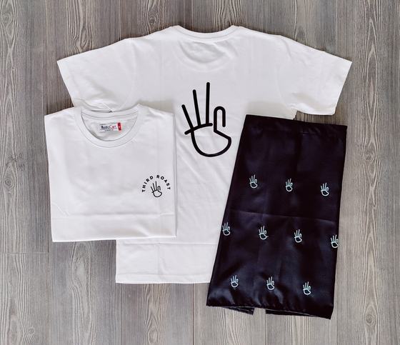 White round neck t-shirts with printed hand sign logo and black waist apron with hand motifs, laid flat, custom made by RestroCart, New Delhi