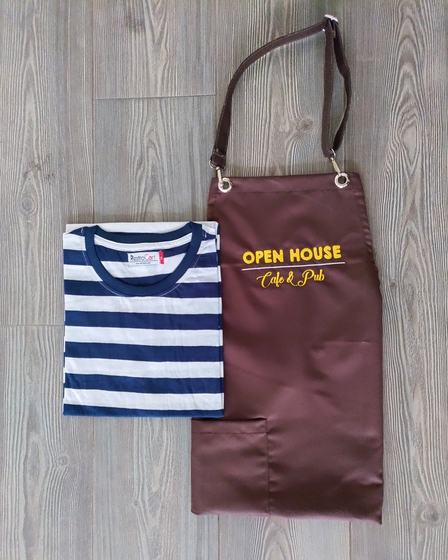Navy and white striped round neck t-shirt with brown bib apron, leather neck strap and yellow embroidered logo, custom made by RestroCart, New Delhi