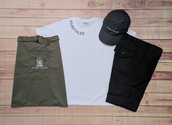 White round-neck t-shirt, dark grey cap, black cargo trousers and olive waist apron with logo, custom made by RestroCart, New Delhi