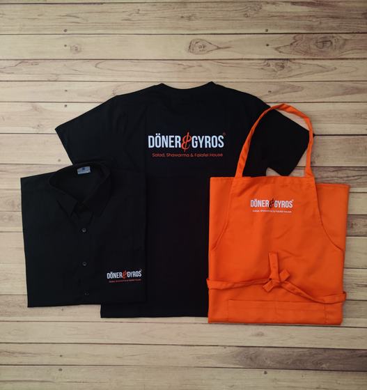 Black round neck t-shirts with white and orange print and orange bib apron with matching logo, custom made by RestroCart, New Delhi