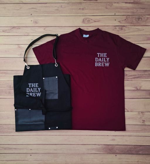 Maroon round neck t-shirt with white print and black denim bib apron with leather trim, custom made by RestroCart, New Delhi