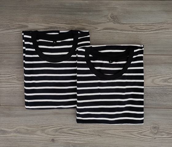 Two black and white horizontal striped round neck t-shirts, folded, custom made by RestroCart, New Delhi