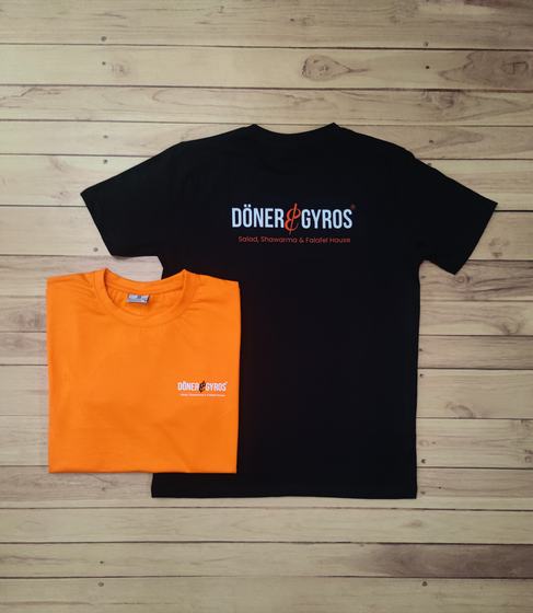 Black and orange round neck t-shirts with white and red printed restaurant wordmark, laid flat, custom made by RestroCart, New Delhi