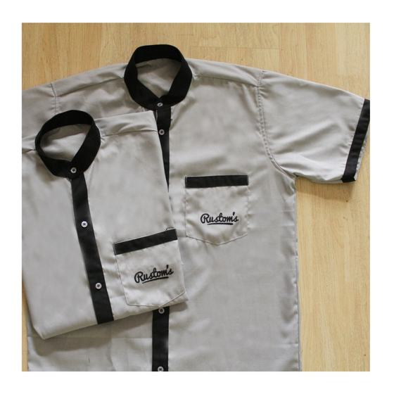 Two grey half sleeve housekeeping tunics with black collar, placket and cuff trim, script logo, custom made for Rustoms by RestroCart, New Delhi