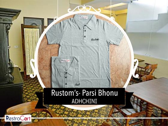 Two light grey polo t-shirts with small black script logo on the chest, one folded, custom made for Rustoms by RestroCart, New Delhi