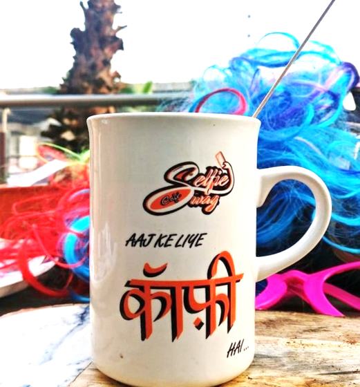 White ceramic mug with red and black logo and Hindi coffee slogan print, custom made for Selfie Swag Cafe by RestroCart, New Delhi