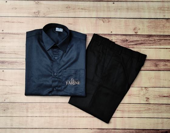Navy service shirt with embroidered pocket logo, folded with black trousers, custom made by RestroCart, New Delhi