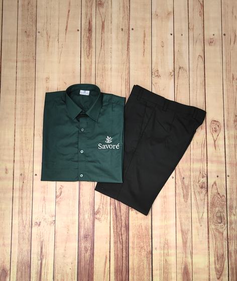 Bottle green service shirt with white embroidered leaf logo, folded with black trousers, custom made by RestroCart, New Delhi