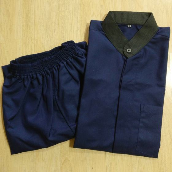 Navy housekeeping tunic with olive green collar and matching navy trousers, close view on wood, custom made for Soho by RestroCart, New Delhi