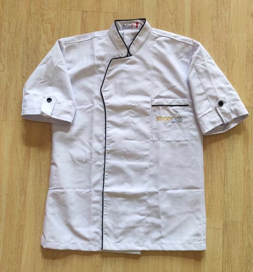 White short sleeve chef coat with black piping and gold embroidered pocket logo, custom made for Sticky Rice by RestroCart, New Delhi