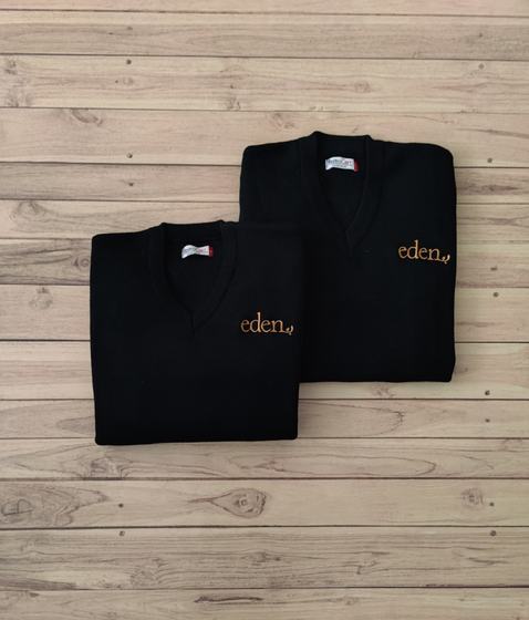 Two black V-neck sweaters with orange embroidered script logo, folded on wood, custom made by RestroCart, New Delhi