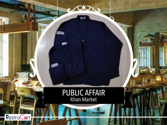 Navy button-front cardigans with small white logo patch on the chest, one folded, one flat, custom made by RestroCart, New Delhi