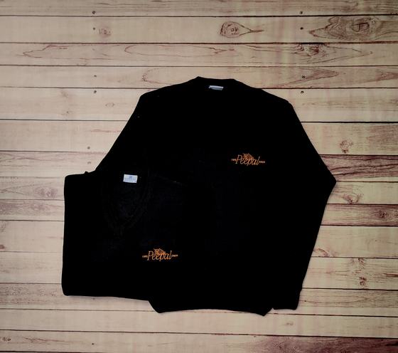 Black V-neck sweaters with orange embroidered script logo on the chest, one folded and one flat, custom made by RestroCart, New Delhi