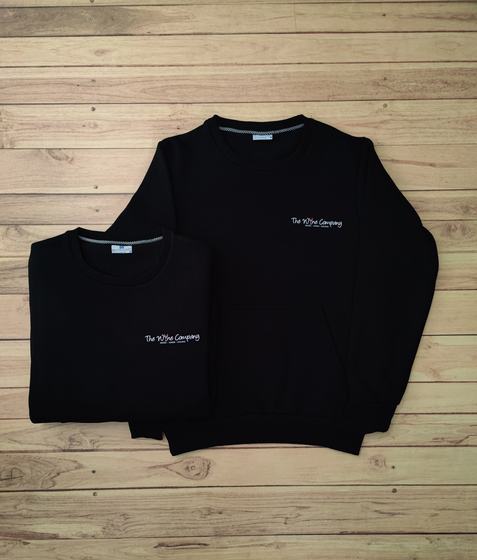 Black crew-neck sweatshirts with small white embroidered text logo, one folded, custom made by RestroCart, New Delhi