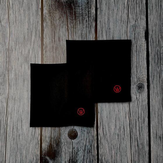 Black cloth table napkins with small red embroidered monogram in the corner, custom made by RestroCart, New Delhi