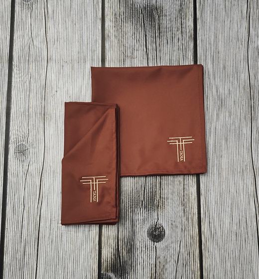 Chocolate brown cloth table napkins with gold embroidered T monogram in the corner, custom made by RestroCart, New Delhi