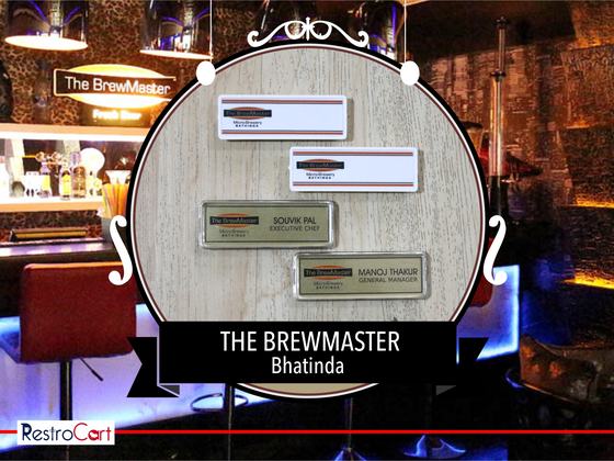 Four rectangular name badges, two white and two brushed gold, with printed names, custom made for The Brewmaster by RestroCart, New Delhi