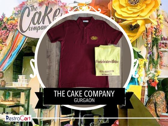 Maroon polo t-shirt with yellow logo and a folded yellow t-shirt with hashtag print, custom made for The Cake Company by RestroCart, New Delhi