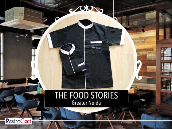 Black short-sleeve housekeeping tunics with white collar and pocket trim, folded, custom made for The Food Stories by RestroCart, New Delhi