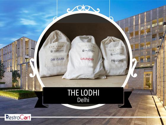 Three white drawstring laundry bags printed dry clean, laundry and pressing, custom made for The Lodhi by RestroCart, New Delhi