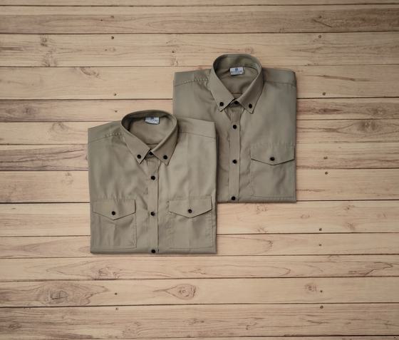 Pair of folded khaki button-down shirts with twin flap chest pockets and dark buttons, on wood, custom made by RestroCart, New Delhi