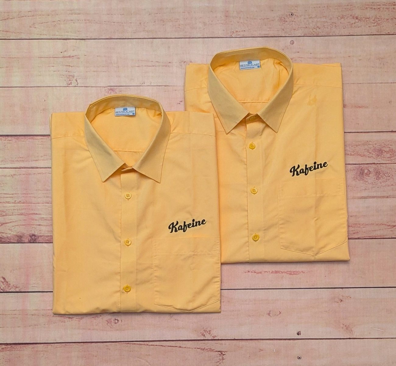 Custom uniform shirts with embroidered chest crests, restaurant uniform branding by RestroCart