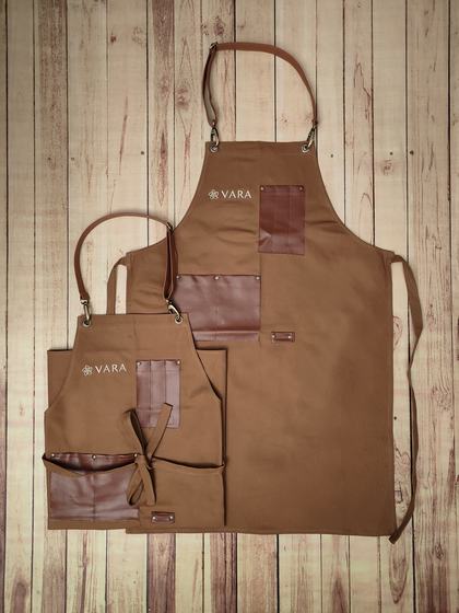Golden brown canvas apron pair with brown leatherette pockets and white printed logo, custom made by RestroCart, New Delhi