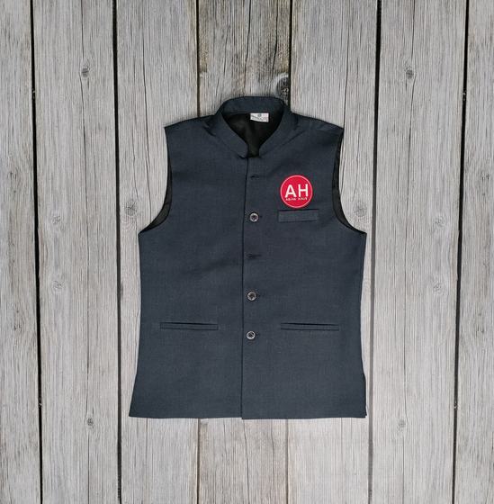 Navy bandhgala style Nehru jacket with round red logo badge, laid on grey wood, custom made by RestroCart, New Delhi