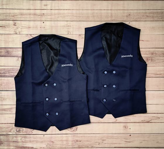 Two navy double-breasted service waistcoats with satin black lining and white embroidered logo, custom made by RestroCart, New Delhi