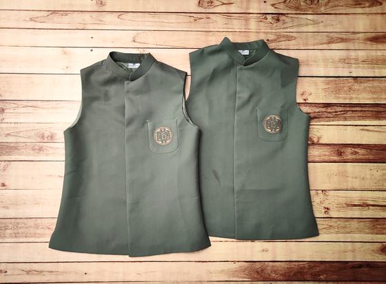 Two olive green Nehru-collar waistcoats with embroidered round crest on the chest pocket, custom made by RestroCart, New Delhi