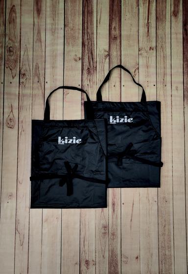 Two black waterproof bib aprons with white printed lowercase wordmark and long waist ties, custom made by RestroCart, New Delhi