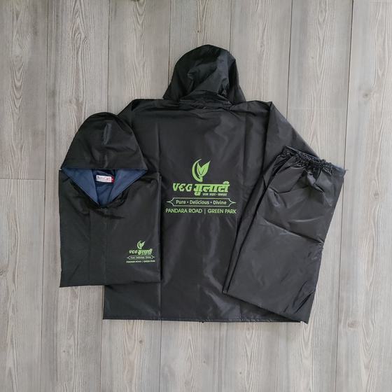 Black hooded raincoat set with jacket and trousers, green printed logo on back, custom made by RestroCart, New Delhi