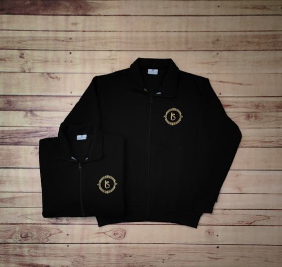Black zip-up fleece jackets with high collar and gold embroidered round monogram, folded and flat, custom made by RestroCart, New Delhi