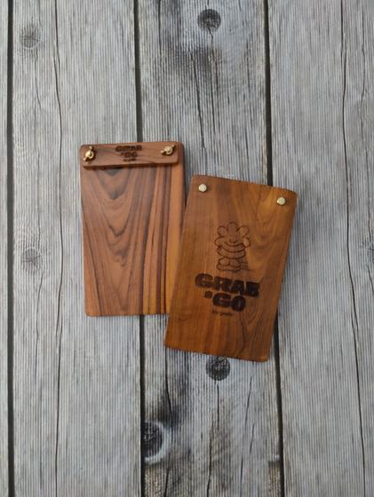 Pair of honey toned wood menu clipboards with engraved header and laser engraved mascot logo, custom made by RestroCart, New Delhi