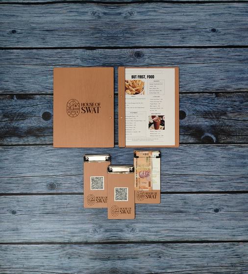 Tan MDF menu cover, printed menu insert and three QR code bill holders on blue wood, custom made by RestroCart, New Delhi