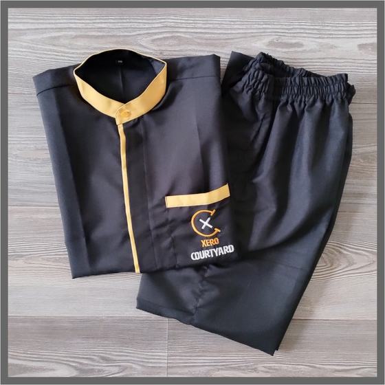 Black housekeeping tunic with yellow collar, placket and pocket trim plus black trousers, custom made for Xero Courtyard by RestroCart, New Delhi