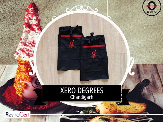 Two black waist aprons with red stripe and red and white logo, laid flat, custom made for Xero Degrees by RestroCart, New Delhi