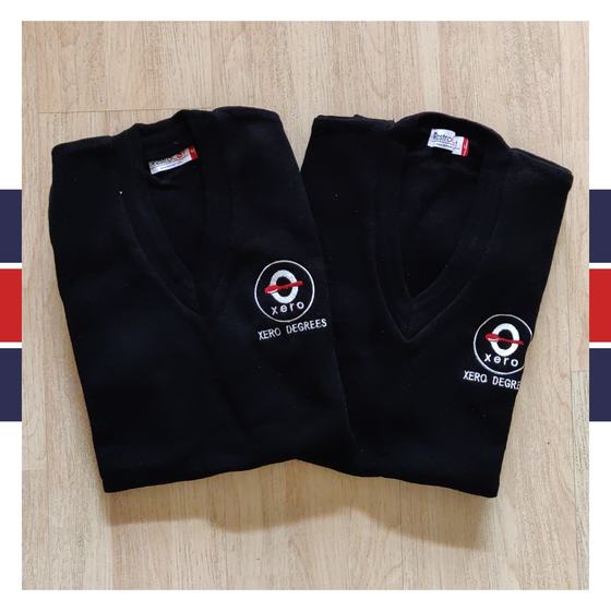 Two black V-neck knit sweaters with white embroidered round logo on chest, folded, custom made for Xero Degrees by RestroCart, New Delhi